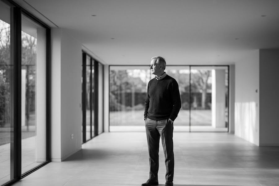 Owner standing alone in a large empty room after selling his company — identity after the exit